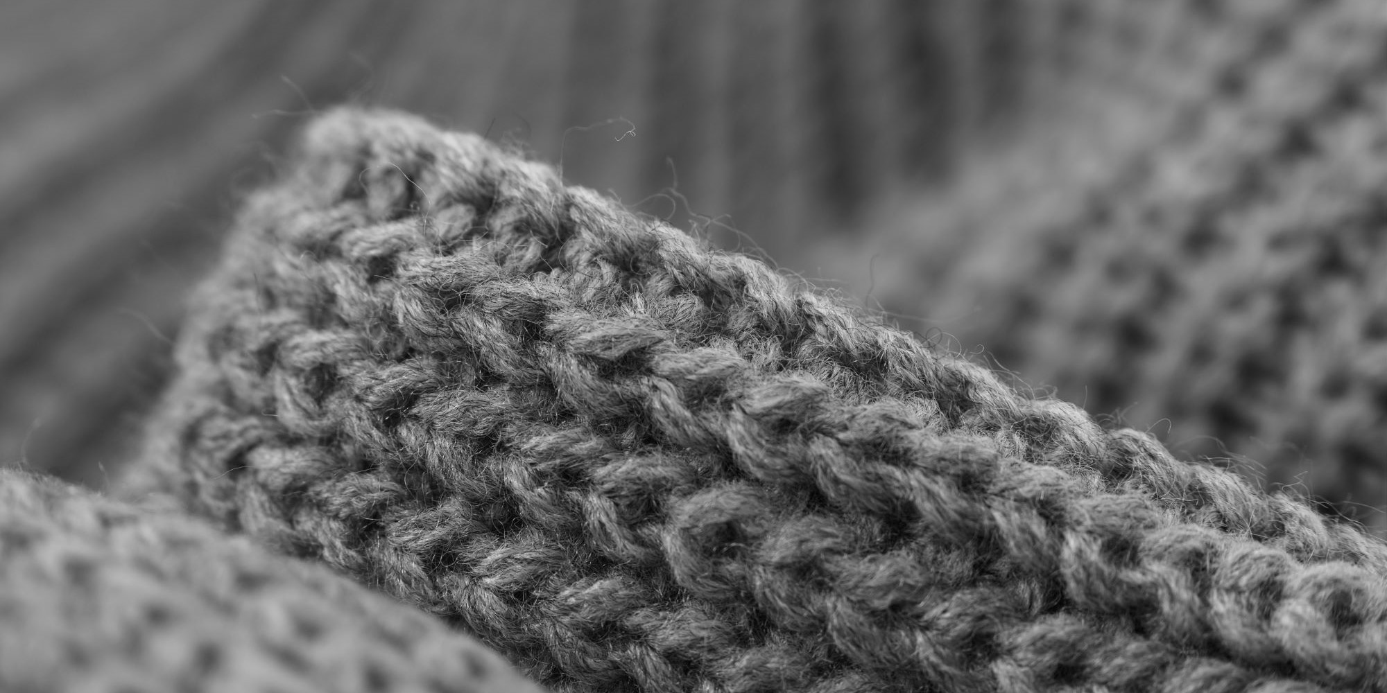 Closeup of a sweater, grey, stockinette stitch.